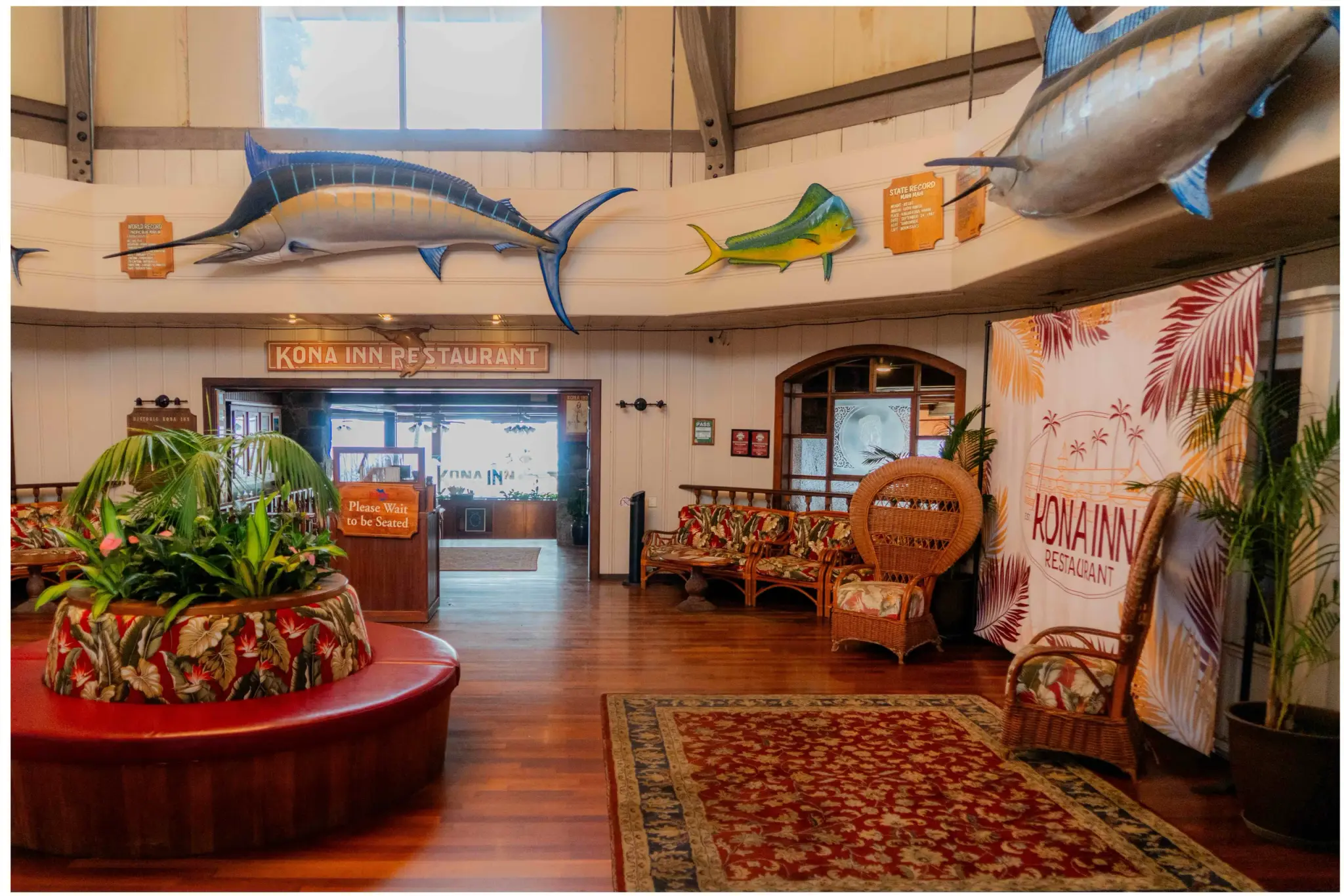 The entrance to Kona Inn Restaurant at Kona Inn Shopping Village, with mounted marlin and mahi mahi above the koa interior