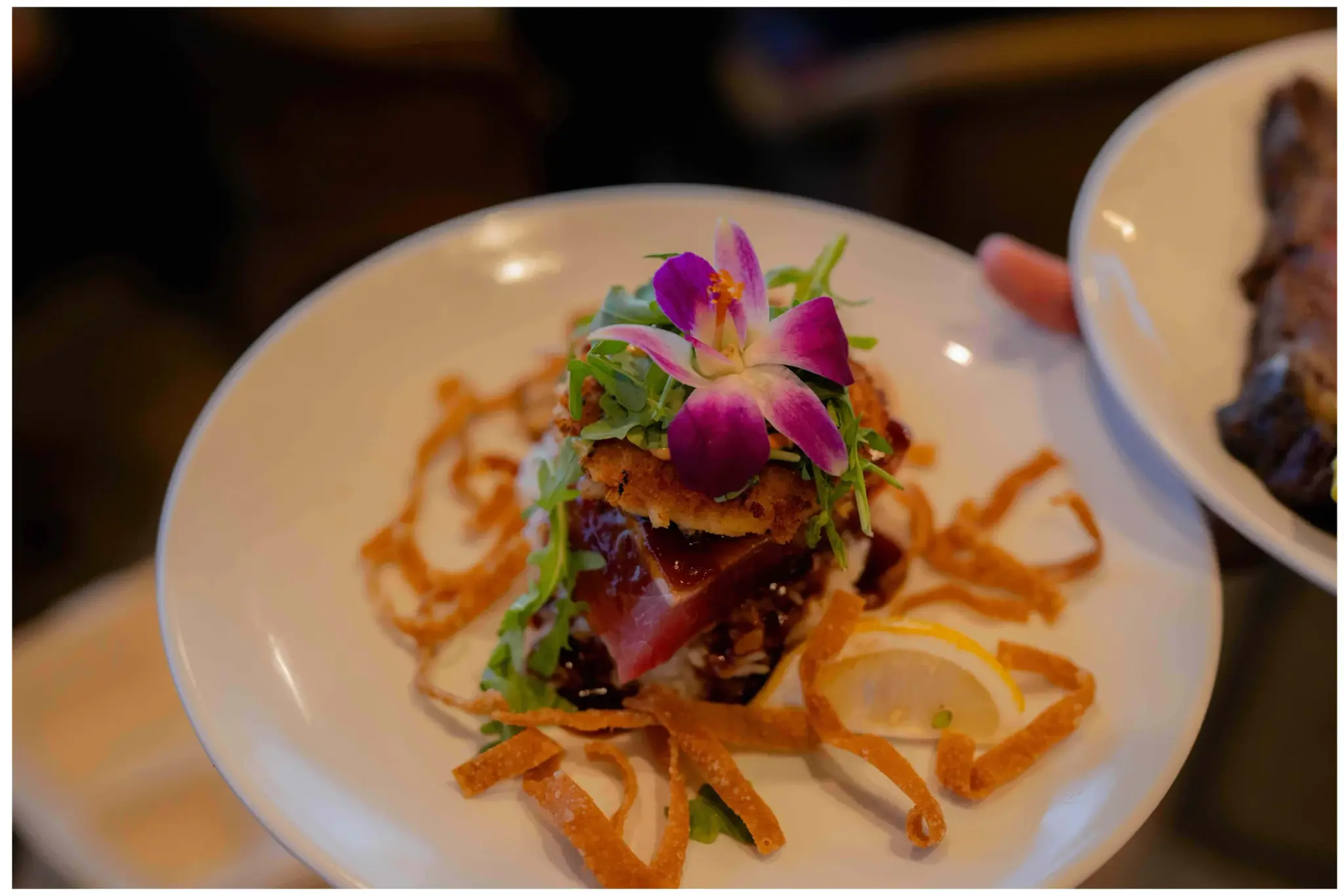 The Seafood Stack at Kona Inn Restaurant, fresh ahi and a crab cake with chili shoyu glaze, crispy wontons and an orchid