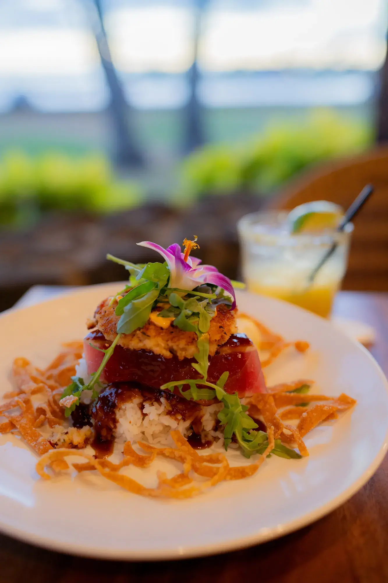 Seafood Stack at Kona Inn Restaurant, Fresh ahi, crab cake, chef rice, red pepper aioli, chili shoyu glaze, crispy wontons.