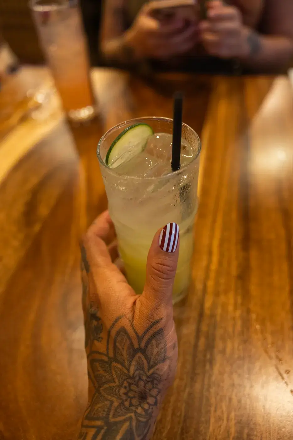 Tall garden smash cocktail with cucumber and lime at the Kona Inn bar on Aliʻi Drive