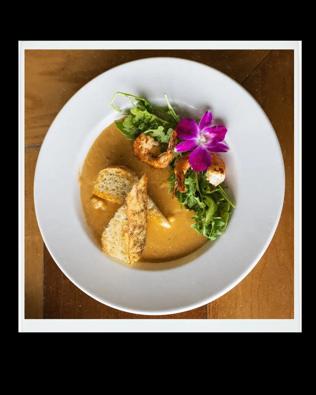 Hawaii Shrimp Bisque at Kona Inn Restaurant served with house focaccia and an orchid garnish