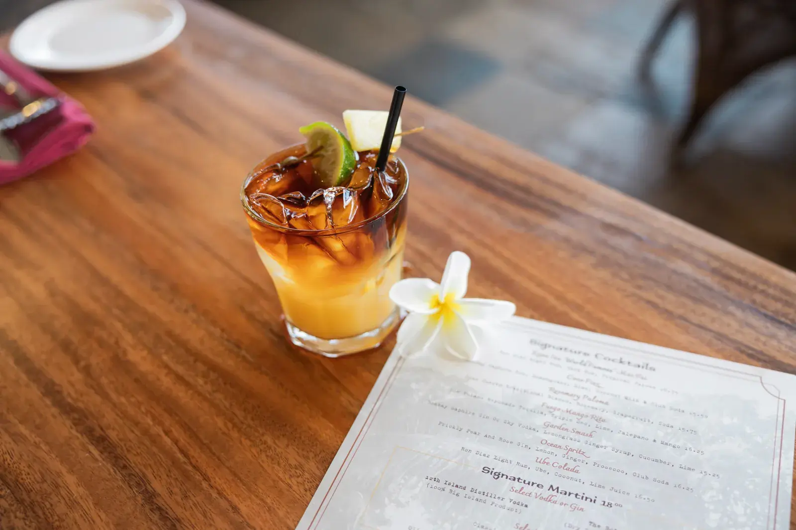 Kona Inn Mai Tai beside the signature cocktails menu on the Koa-wood bar in Kailua-Kona